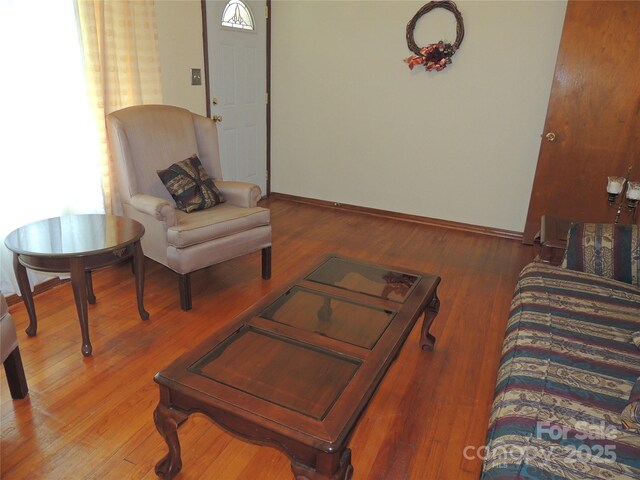living area featuring wood finished floors and baseboards