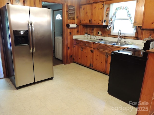 kitchen featuring a sink, stainless steel fridge with ice dispenser, black range with electric stovetop, and brown cabinets