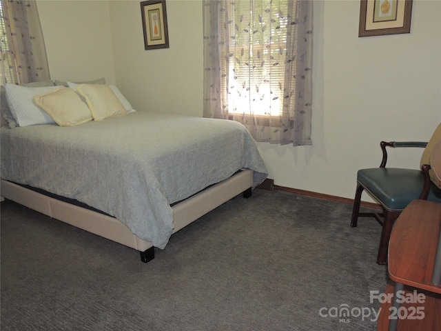 carpeted bedroom featuring baseboards