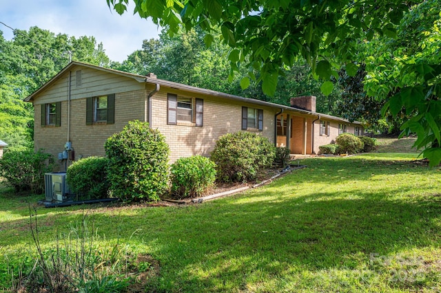 2871 Loviee Rd, Lincolnton, NC 28092 - ranch-style home featuring a front lawn, a chimney, brick siding, and central AC unit