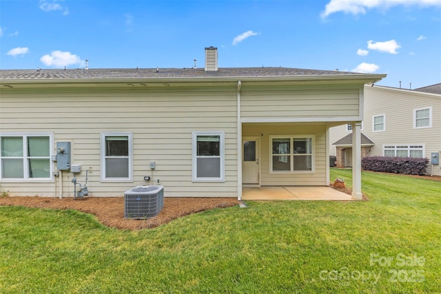 8505 Loxton Cir, Charlotte, NC 28214 - rear view of property with central air condition unit, a patio area, a chimney, and a yard