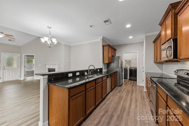 8505 Loxton Cir, Charlotte, NC 28214 - kitchen featuring light wood finished floors, visible vents, a sink, washing machine and clothes dryer, and appliances with stainless steel finishes