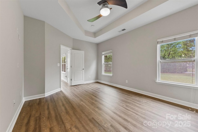 8505 Loxton Cir, Charlotte, NC 28214 - unfurnished room with baseboards, a ceiling fan, visible vents, and wood finished floors