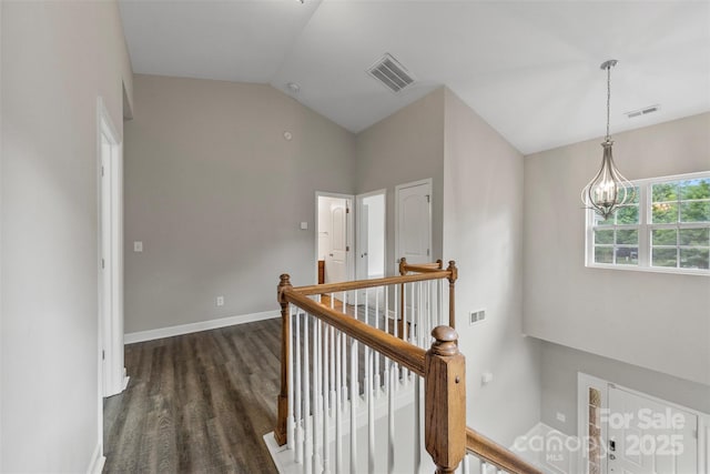 8505 Loxton Cir, Charlotte, NC 28214 - corridor featuring vaulted ceiling, dark wood finished floors, visible vents, and an upstairs landing