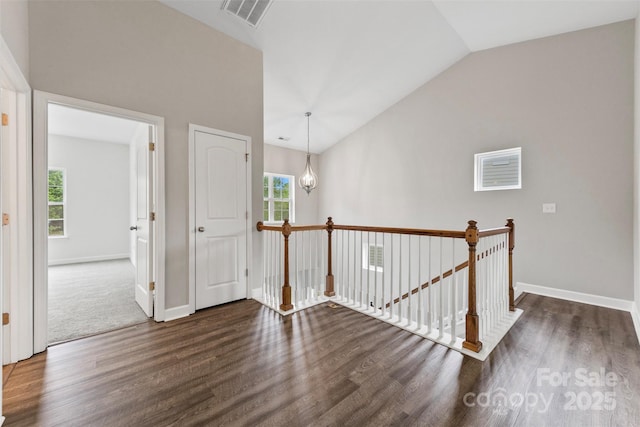 8505 Loxton Cir, Charlotte, NC 28214 - hallway featuring baseboards, visible vents, high vaulted ceiling, wood finished floors, and an upstairs landing