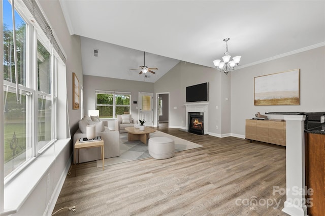 8505 Loxton Cir, Charlotte, NC 28214 - living room featuring baseboards, visible vents, a fireplace with flush hearth, vaulted ceiling, and wood finished floors