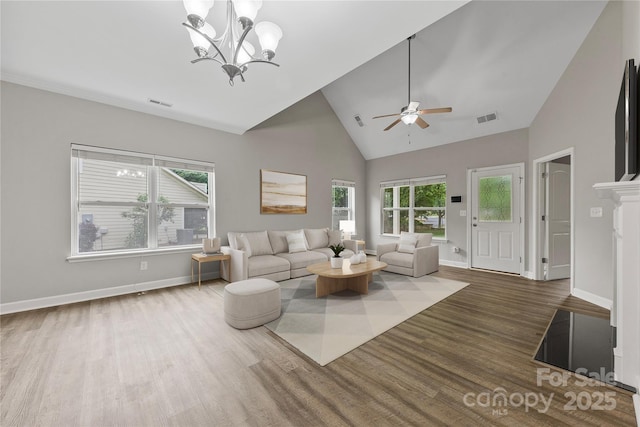 8505 Loxton Cir, Charlotte, NC 28214 - living room featuring visible vents, wood finished floors, ceiling fan with notable chandelier, and high vaulted ceiling