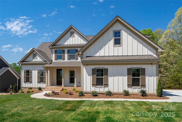 modern farmhouse with covered porch, a front yard, a shingled roof, and board and batten siding