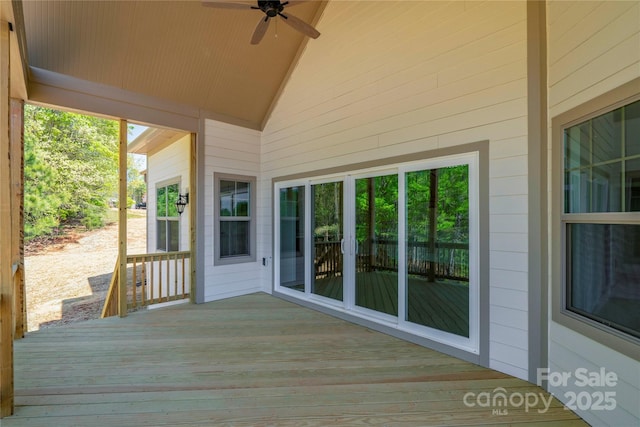 wooden deck featuring ceiling fan