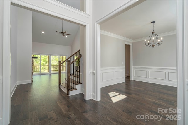 foyer entrance featuring stairs, ceiling fan with notable chandelier, crown molding, and wood finished floors