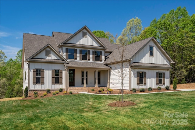 view of front of home with a front lawn, board and batten siding, a porch, and a shingled roof