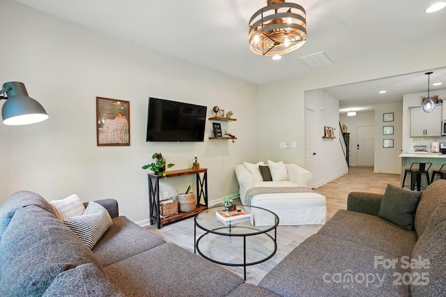 12021 Basking Dr, Charlotte, NC 28214 - living room featuring light wood-style flooring, baseboards, and recessed lighting
