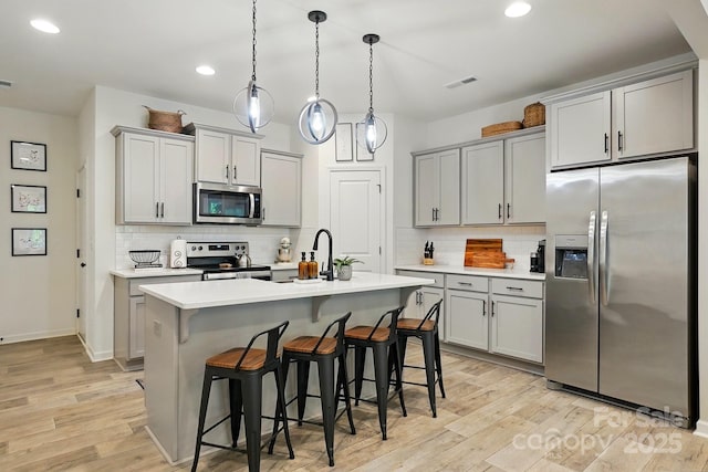 12021 Basking Dr, Charlotte, NC 28214 - kitchen with appliances with stainless steel finishes, gray cabinetry, a sink, decorative backsplash, and recessed lighting