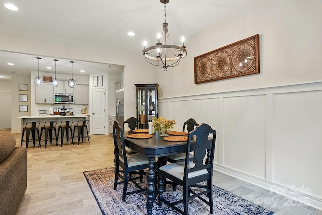 12021 Basking Dr, Charlotte, NC 28214 - dining room featuring a decorative wall, a chandelier, light wood finished floors, recessed lighting, and a wainscoted wall