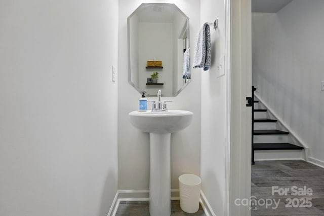12021 Basking Dr, Charlotte, NC 28214 - bathroom with baseboards, wood finished floors, and a sink
