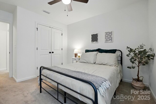 12021 Basking Dr, Charlotte, NC 28214 - bedroom featuring light carpet, baseboards, a closet, and ceiling fan