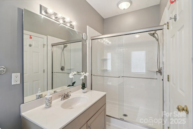 full bath featuring vanity and a shower stall