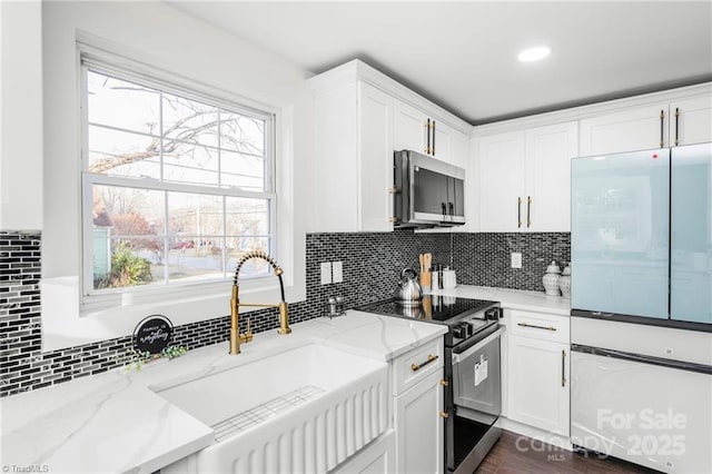 900 Gales Ave, Winston Salem, NC 27103 - kitchen featuring freestanding refrigerator, black electric range oven, light stone counters, stainless steel microwave, and white cabinets