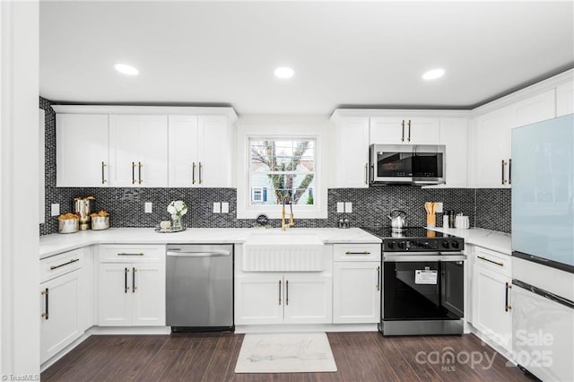 900 Gales Ave, Winston Salem, NC 27103 - kitchen with a sink, stainless steel appliances, white cabinetry, and backsplash