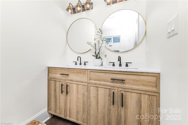 900 Gales Ave, Winston Salem, NC 27103 - full bathroom featuring a sink, double vanity, baseboards, and wood finished floors