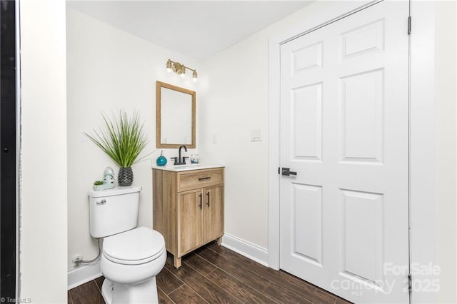 900 Gales Ave, Winston Salem, NC 27103 - bathroom with vanity, wood finished floors, baseboards, and toilet