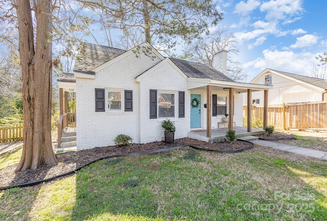 3141 Mathis Dr, Charlotte, NC 28208 - bungalow-style house featuring a porch, fence, a chimney, and brick siding