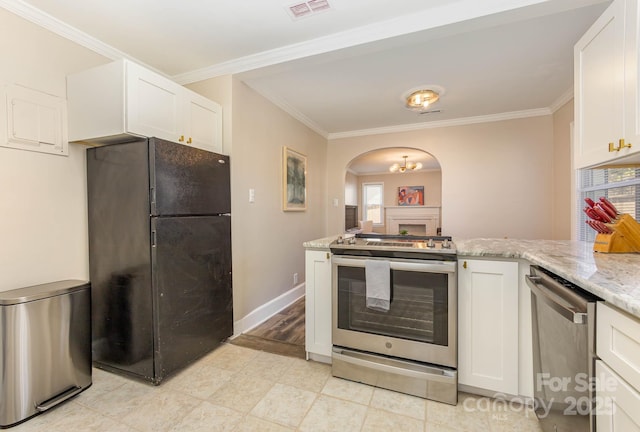 3141 Mathis Dr, Charlotte, NC 28208 - kitchen featuring a peninsula, white cabinets, visible vents, arched walkways, and appliances with stainless steel finishes