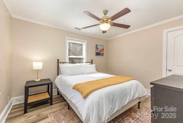 3141 Mathis Dr, Charlotte, NC 28208 - bedroom with light wood-style flooring, a ceiling fan, visible vents, baseboards, and ornamental molding