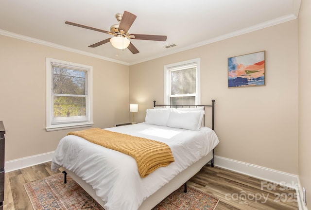 3141 Mathis Dr, Charlotte, NC 28208 - bedroom with a ceiling fan, baseboards, visible vents, crown molding, and wood finished floors