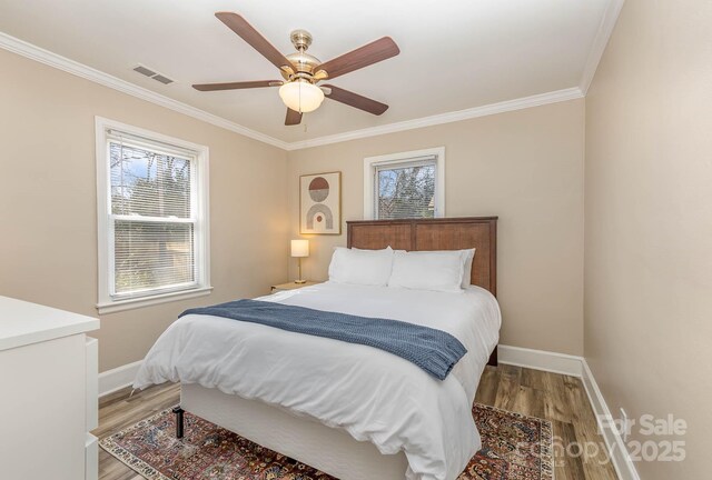 3141 Mathis Dr, Charlotte, NC 28208 - bedroom with wood finished floors, visible vents, crown molding, a ceiling fan, and baseboards