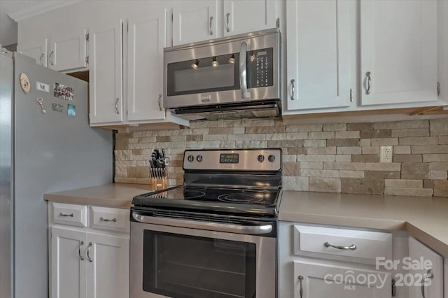 kitchen with stainless steel appliances, light countertops, and white cabinetry
