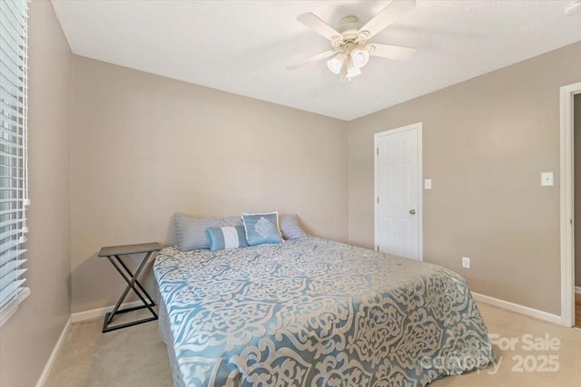 bedroom with light colored carpet, baseboards, and ceiling fan