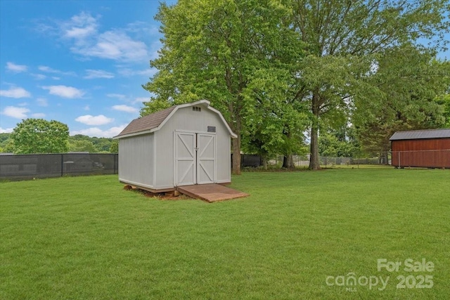view of yard featuring a storage unit and an outdoor structure
