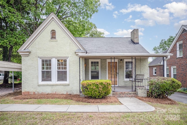 813 S Ridge Ave, Kannapolis, NC 28083 - view of front facade with covered porch, a chimney, and brick siding