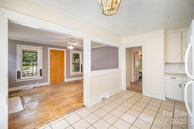 813 S Ridge Ave, Kannapolis, NC 28083 - spare room featuring crown molding, baseboards, a ceiling fan, and light wood finished floors