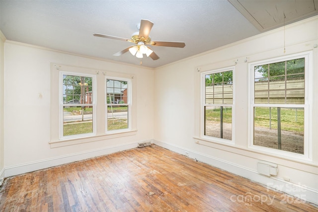 813 S Ridge Ave, Kannapolis, NC 28083 - spare room featuring attic access, healthy amount of natural light, wood finished floors, baseboards, and crown molding