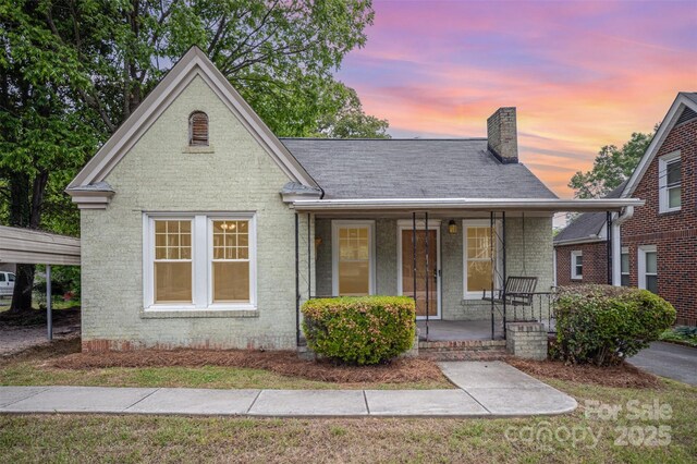 813 S Ridge Ave, Kannapolis, NC 28083 - view of front of property with a porch, a chimney, brick siding, and a shingled roof