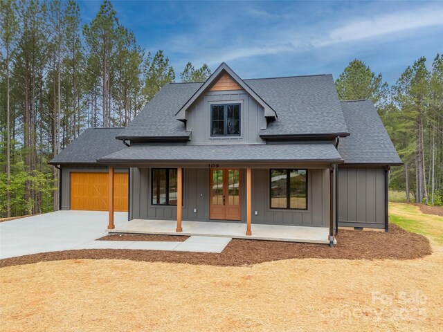 109 Ashley Ct, Mill Spring, NC 28756 - view of front of home featuring french doors, a porch, board and batten siding, and a shingled roof