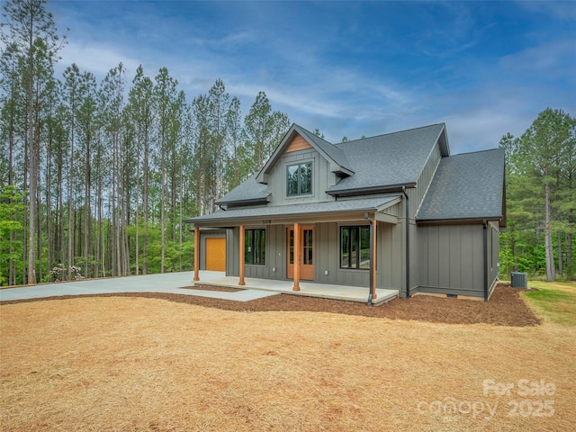 109 Ashley Ct, Mill Spring, NC 28756 - back of house with board and batten siding, cooling unit, a porch, a shingled roof, and concrete driveway