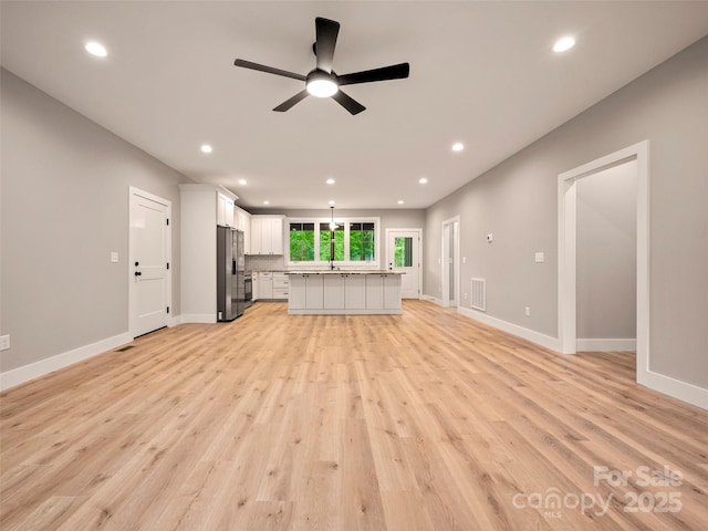 109 Ashley Ct, Mill Spring, NC 28756 - unfurnished living room with recessed lighting, ceiling fan, light wood-style floors, baseboards, and a sink