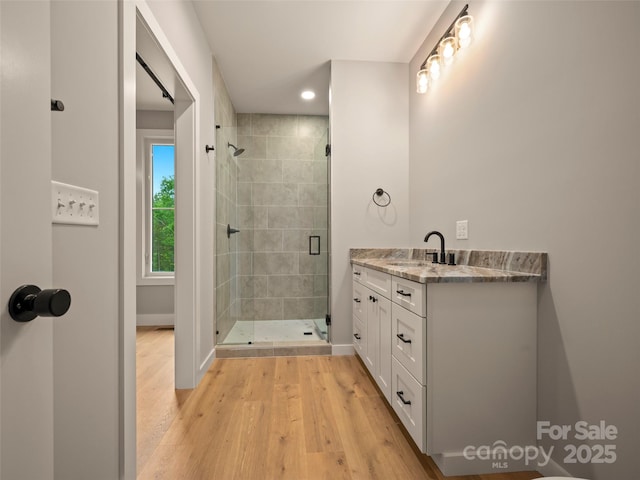 109 Ashley Ct, Mill Spring, NC 28756 - bathroom featuring a stall shower, baseboards, wood finished floors, vanity, and recessed lighting