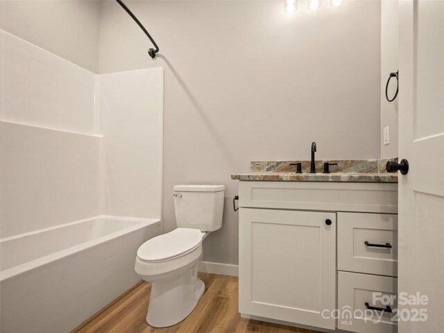 109 Ashley Ct, Mill Spring, NC 28756 - full bathroom featuring wood finished floors, baseboards, vanity, toilet, and  shower combination