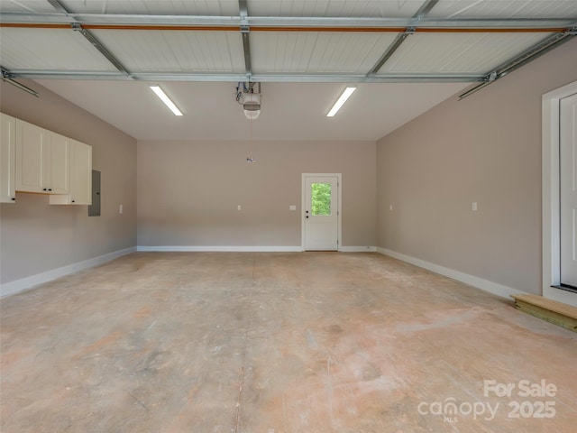 109 Ashley Ct, Mill Spring, NC 28756 - garage with baseboards, a garage door opener, and electric panel