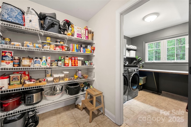 storage area featuring washer and clothes dryer