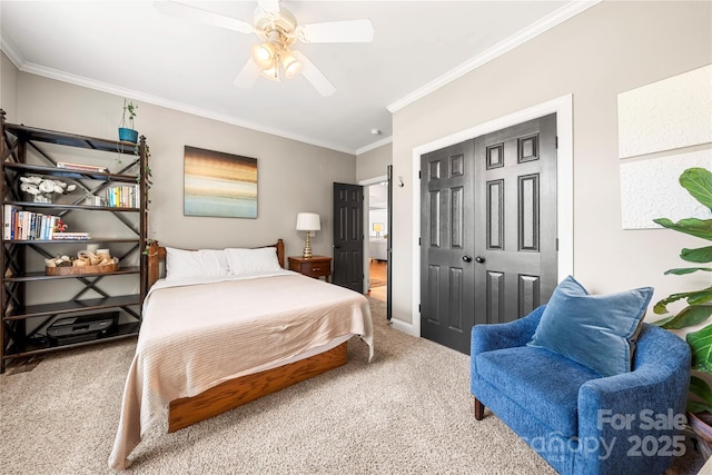 bedroom with carpet floors, crown molding, a closet, a ceiling fan, and baseboards