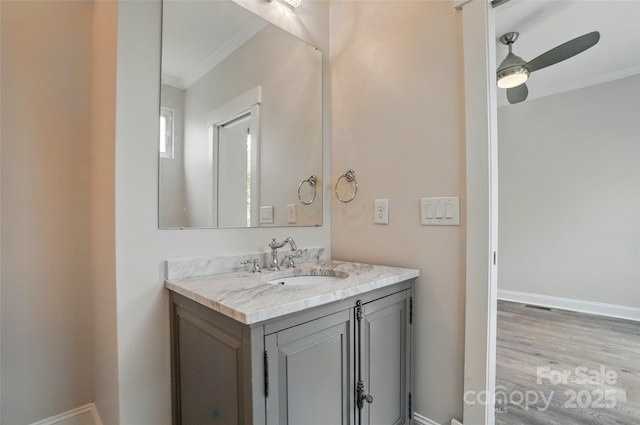 945 Westbrook Dr Unit A, Charlotte, NC 28202 - bathroom with ornamental molding, vanity, wood finished floors, and ceiling fan