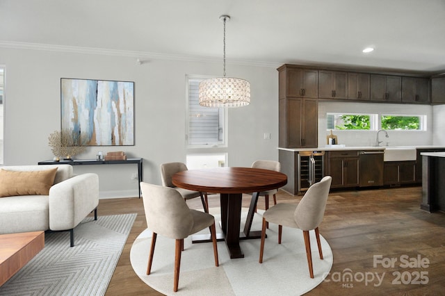 945 Westbrook Dr Unit A, Charlotte, NC 28202 - dining space with beverage cooler, ornamental molding, dark wood-type flooring, a chandelier, and recessed lighting