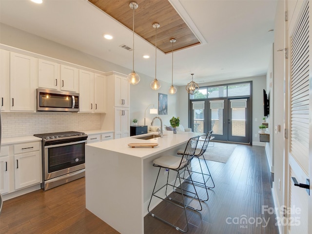 2401 Euclid Ave Unit 207, Charlotte, NC 28203 - kitchen featuring appliances with stainless steel finishes, a sink, french doors, white cabinetry, and recessed lighting
