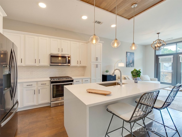 2401 Euclid Ave Unit 207, Charlotte, NC 28203 - kitchen with appliances with stainless steel finishes, a sink, tasteful backsplash, white cabinetry, and recessed lighting