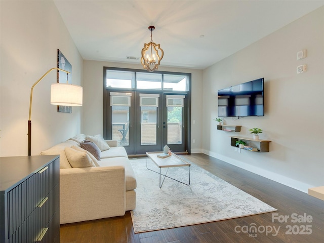 2401 Euclid Ave Unit 207, Charlotte, NC 28203 - living area featuring a chandelier, wood finished floors, baseboards, and french doors